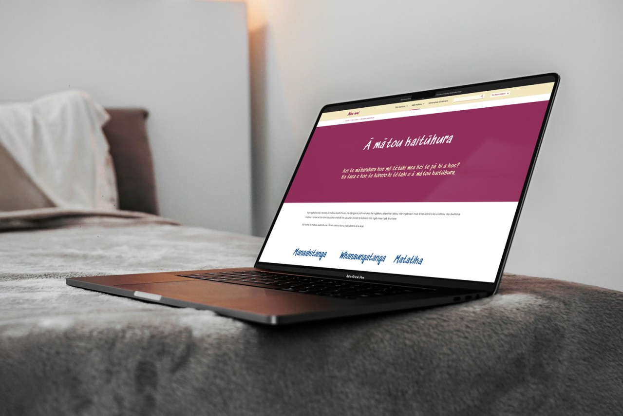 nau-mai.nz website shown on a laptop on a bed